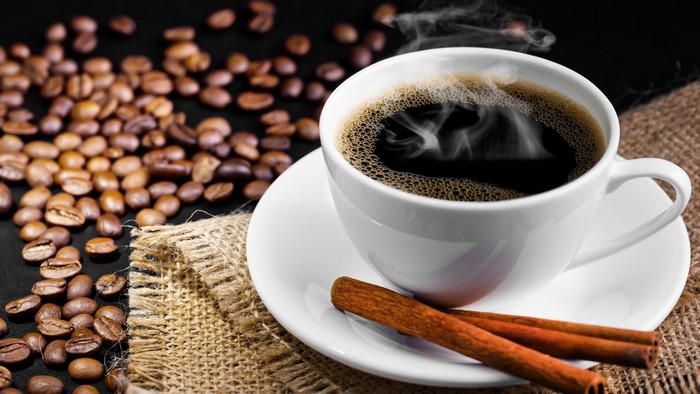 Hot Coffee Cup with Cinnamon Sticks and Beans