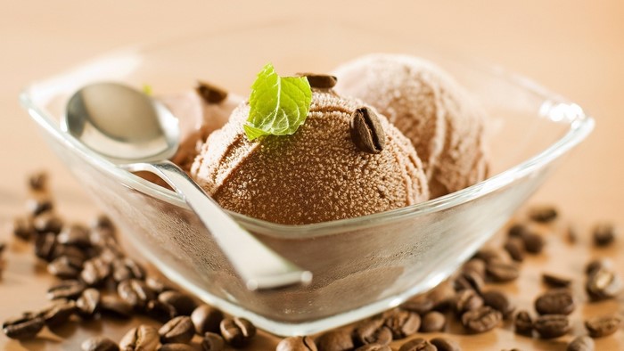 Coffee ice cream in a glass bowl with coffee beans