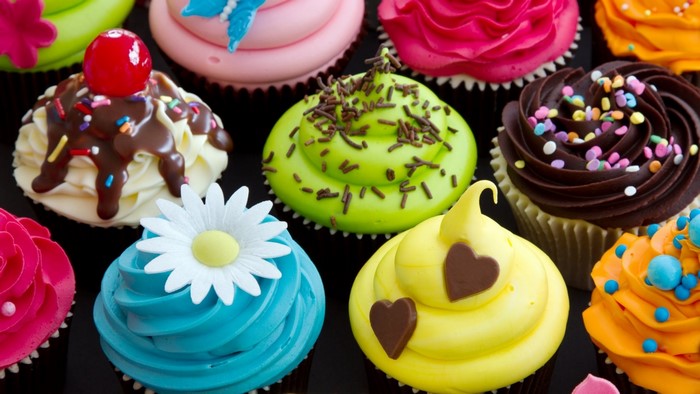 Colorful cupcakes with various toppings