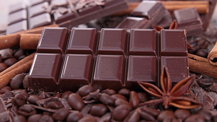 Chocolate bar with coffee beans and cinnamon sticks