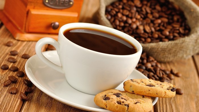 Coffee cup with cookies and coffee beans