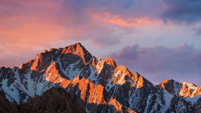 Mountain peaks at sunset with colorful clouds