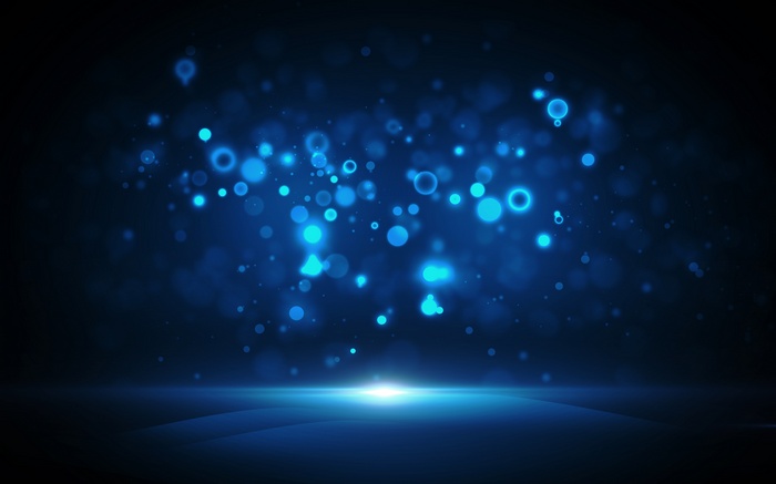 Abstract blue bokeh lights on dark background