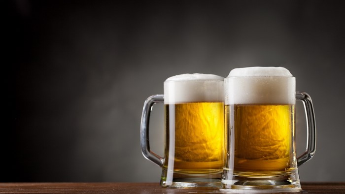 Two glasses of beer with foam