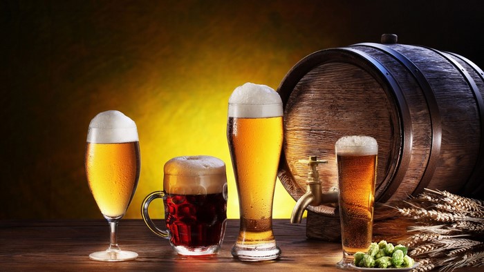 Beer glasses and barrel with hops and wheat