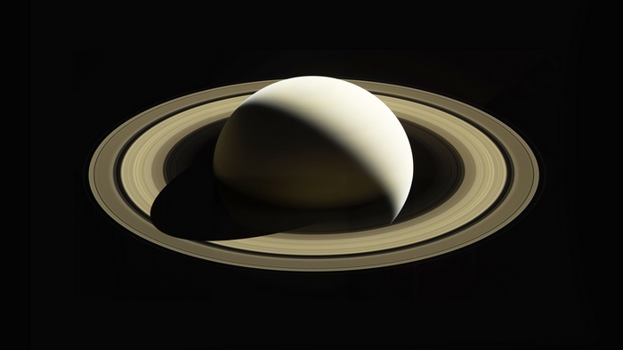 Saturn and its rings casting a shadow