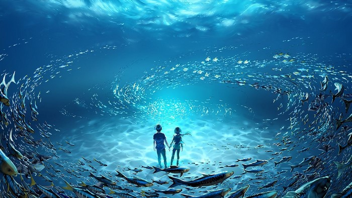 Couple holding hands underwater with fish
