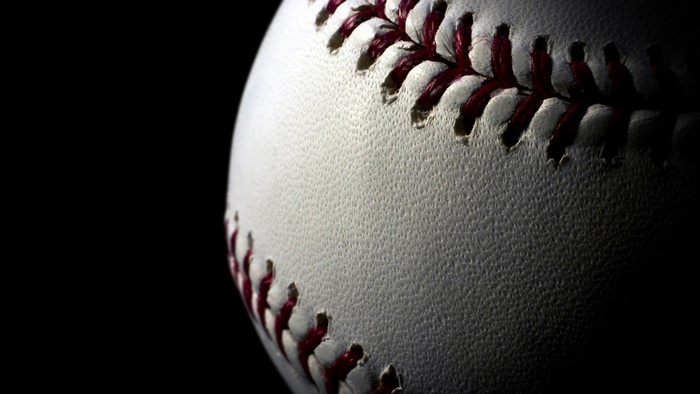 Close-up of a baseball with red stitching