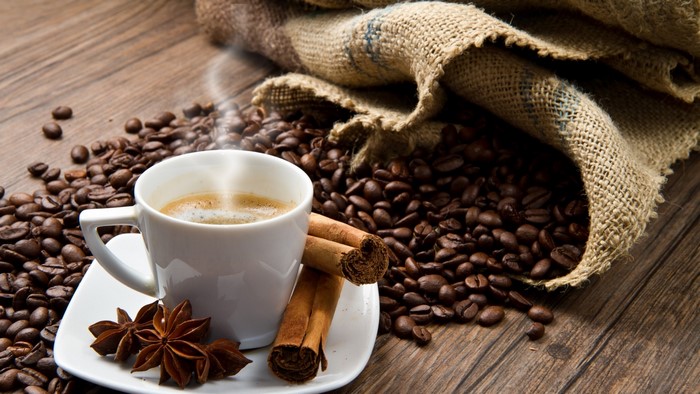 Coffee cup with beans and spices