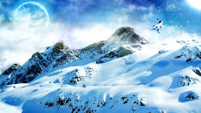 Snowboarder jumping over snowy mountains under a large moon