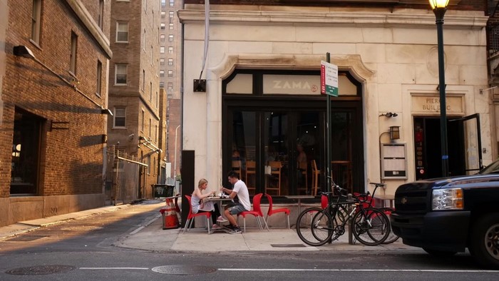 People eating outside Zama restaurant
