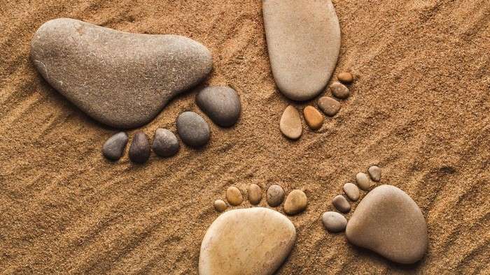 Footprints made of stones on sand
