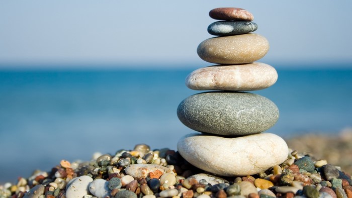 Stack of stones on a beach with ocean background