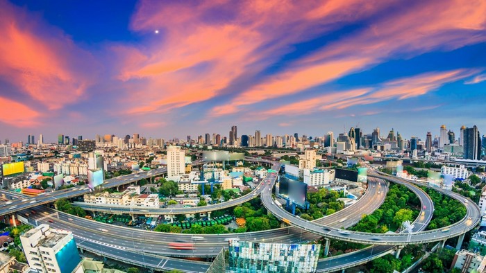 Bangkok cityscape with highway interchange at sunset