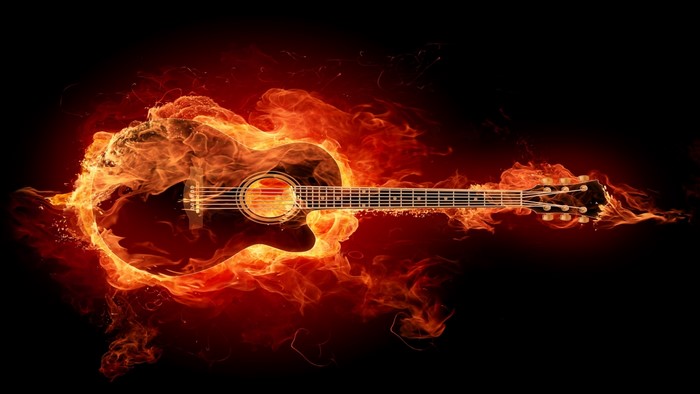 Acoustic guitar engulfed in flames
