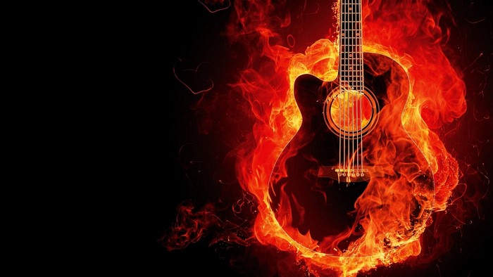 Acoustic guitar engulfed in flames