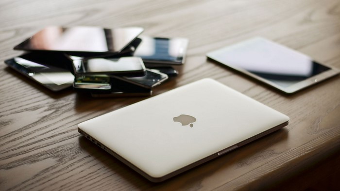 Apple Laptop and Tablets on Wooden Table