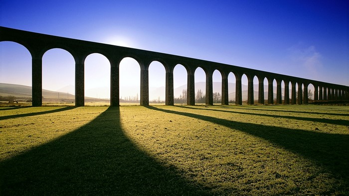 Stone Aqueduct with Arches and Shadows
