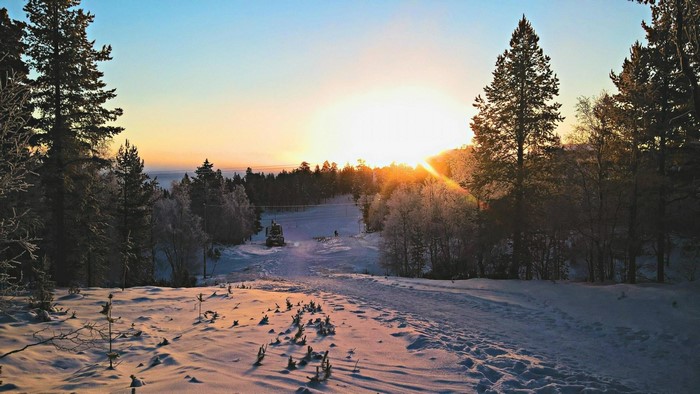 Sunset over snowy forest in Lappland, Finland