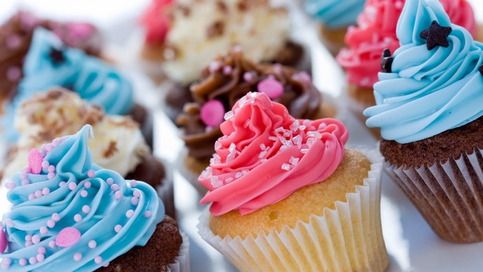 Assortment of colorful cupcakes with frosting