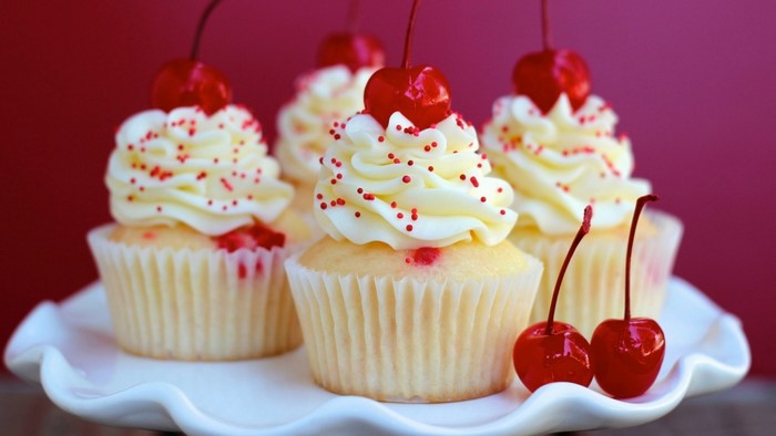 Cupcakes with white frosting and cherries