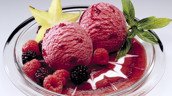 Raspberry ice cream with berries and star fruit