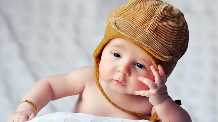 Cute baby wearing a brown hat