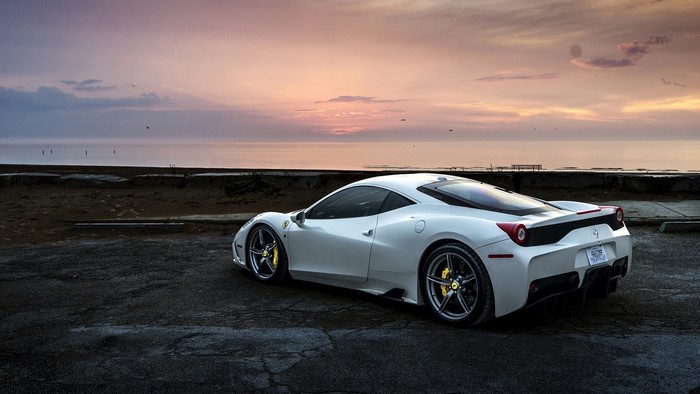 White Ferrari 458 Spider by the ocean at sunset