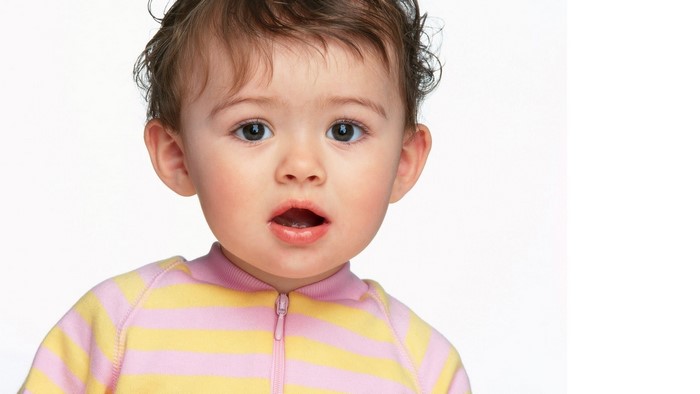 Cute baby wearing a pink and yellow striped outfit