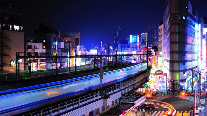 Tokyo street at night with train light trails