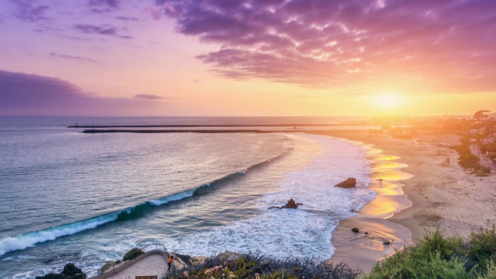 Sunset over Corona Del Mar beach in Newport Beach