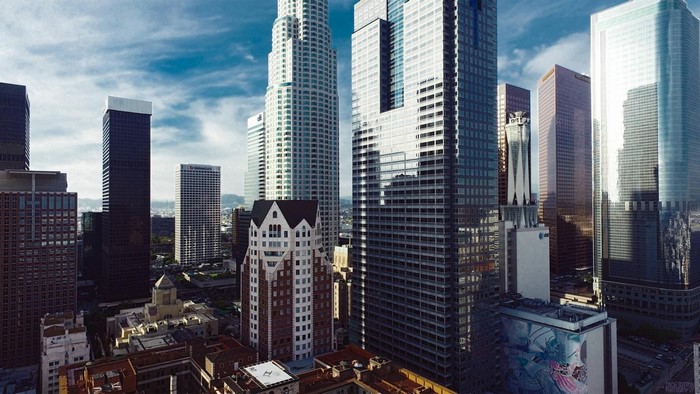 Downtown Los Angeles skyscrapers under a cloudy sky