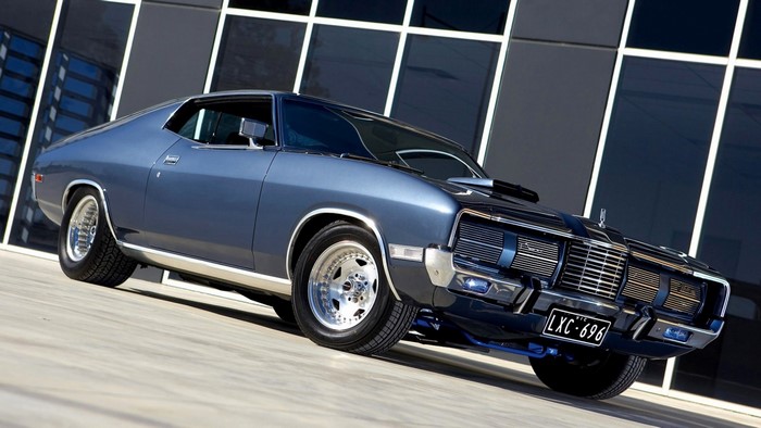Classic blue Ford car with custom wheels