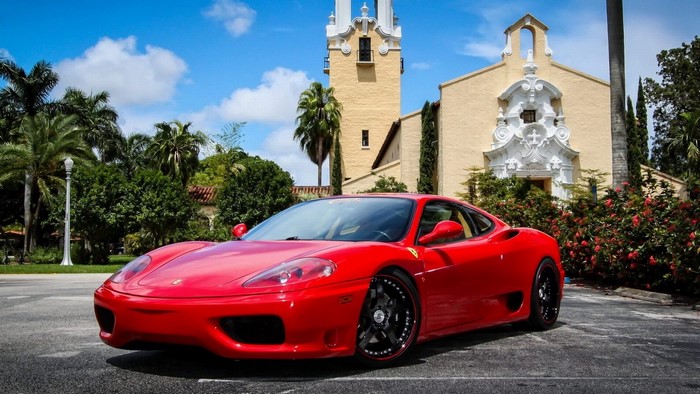 Red Ferrari 360 Modena in front of a building