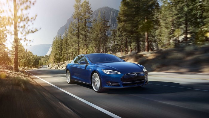 Blue Tesla Model S driving on a mountain road