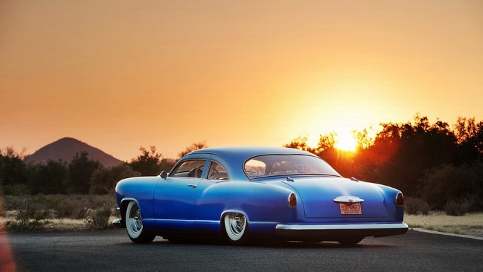 Blue Kaiser car at sunset