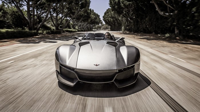 Rezvani Beast car driving on a tree-lined road