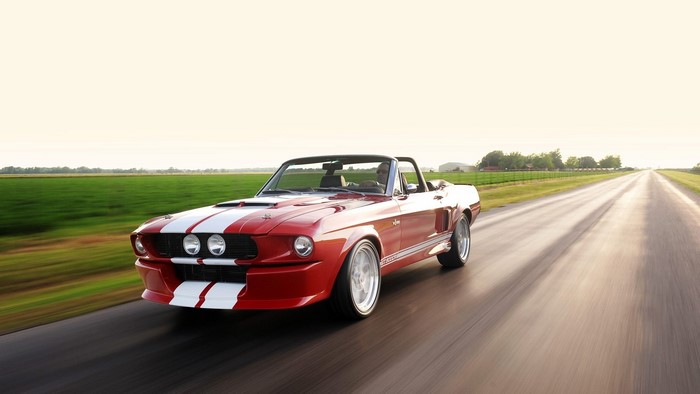 Red Shelby GT 500 Convertible Driving on Road