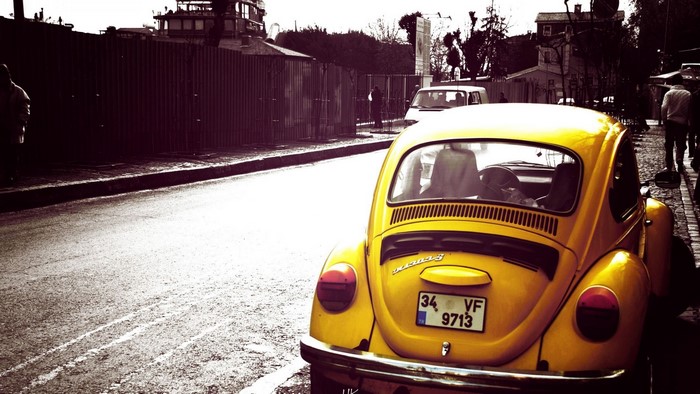 Yellow Volkswagen Beetle on a Street