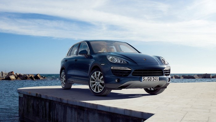Porsche Cayenne parked on a pier by the sea