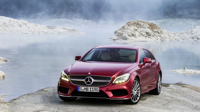 Red Mercedes-Benz CLS parked by a lake