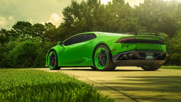 Green Lamborghini Huracan on a paved road