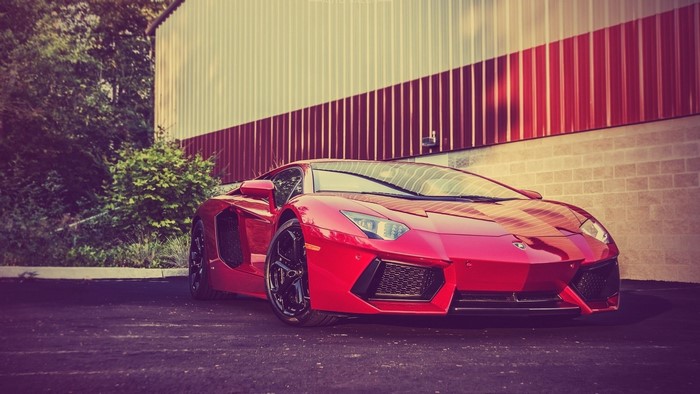 Red Lamborghini Aventador parked outside building