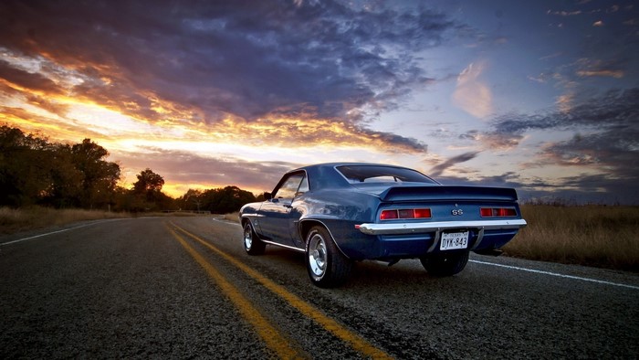 1969 Chevrolet Camaro SS on a road at sunset