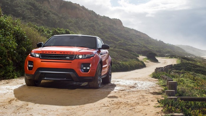 Orange Range Rover Evoque on a dirt road