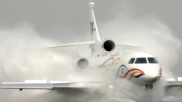 White private jet undergoing a water salute