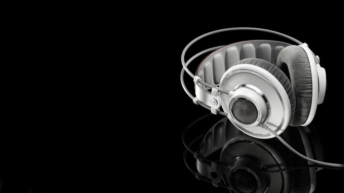 White and gray headphones on black background