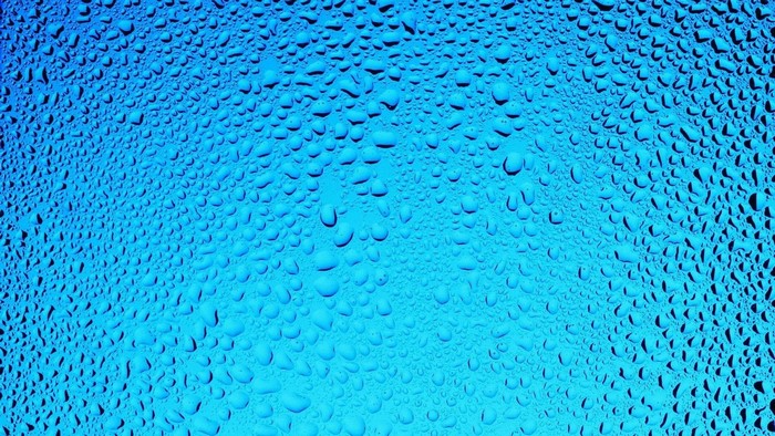 Blue water droplets on a gradient background