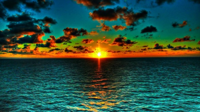 Sunset over the ocean with colorful clouds