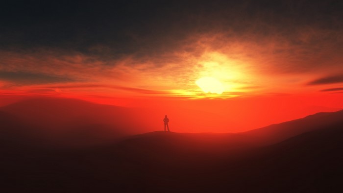 Silhouette of a person against a vibrant sunset